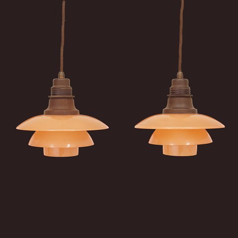 Pair of Poul Henningsen PH2/2 pendants with salmon 
coloured glass shades. Denmark 1930s. D: 20cm