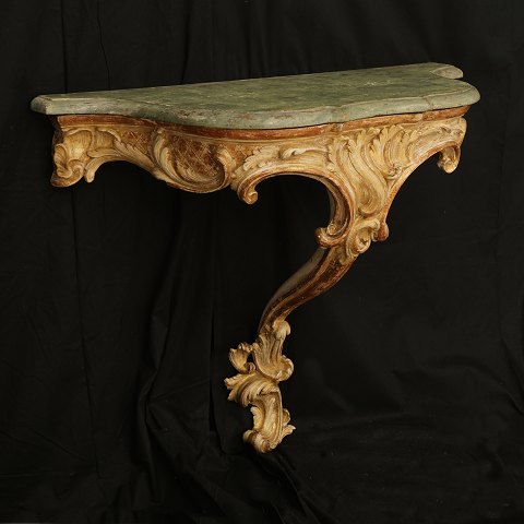 A gilt 18th century Rococo console table. Denmark 
circa 1750. H: 78cm. Plate: 90x40cm