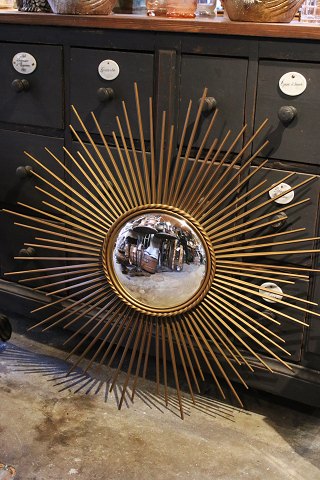 Large French sun mirror from the 50s. in gold metal with caged mirror glass from 
Chaty Vallauris.