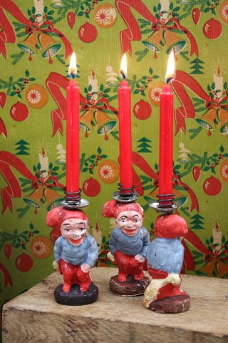 Cute little Santas with geese on their backs in painted plaster 
with a candle holder at the top...