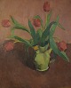 Wils, Vilhelm (1880 - 1960) Denmark: Arrangement with red tulips in a jug.