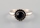 Ring in sterling silver by Georg Jensen, adorned with cabochon cut black agate.