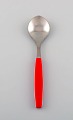 Henning Koppel for Georg Jensen. Strata teaspoon in stainless steel and red 
plastic.
