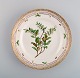 Royal Copenhagen Flora Danica plate in hand-painted porcelain with flowers and 
gold decoration. Dated 1952.
