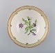 Porcelain bowl with hand-painted flowers and gold decoration. Flora Danica 
style. Dated 1979.
