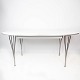 Super Ellipse dining table with white laminate designed by Piet Hein and Arne 
Jacobsen, and manufactured by Fritz Hansen in 2011.
