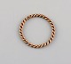 Scandinavian jeweler. Braided ring in 8 carat gold. Mid-20th century.

