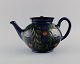 Kähler, HAK. Large teapot in glazed ceramics. Flowers and foliage on a dark blue 
background. 1930s / 40s.
