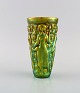 Zsolnay vase in glazed ceramics modeled with women picking grapes. Beautiful 
luster glasses. Mid-20th century.
