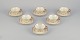 A set of six KP, Karlskrona tea cups with saucers in cream-colored porcelain with gold decoration.