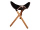 StoolBlack leather and foldable wooden legs