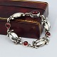 Antik Damgaard-Lauritsen præsenterer: Georg Jensen; "Moonlight Blossom" armbånd af sterling sølv med granat, nr. 11