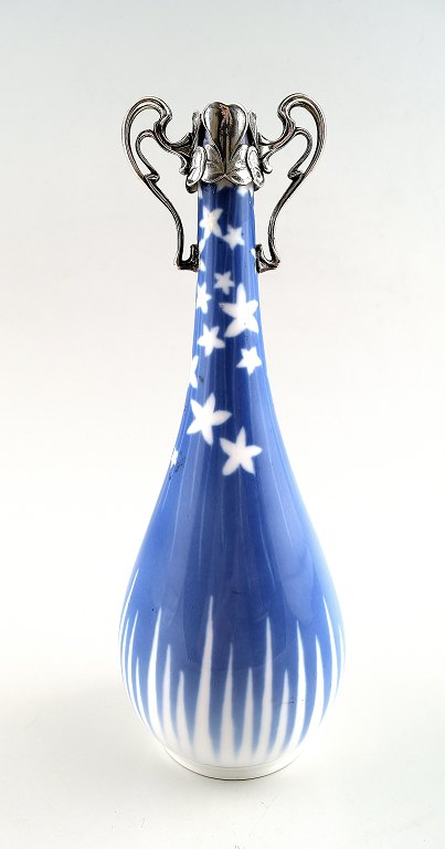 Royal Copenhagen Art Nouveau vase with silver mounts, decorated with stars.