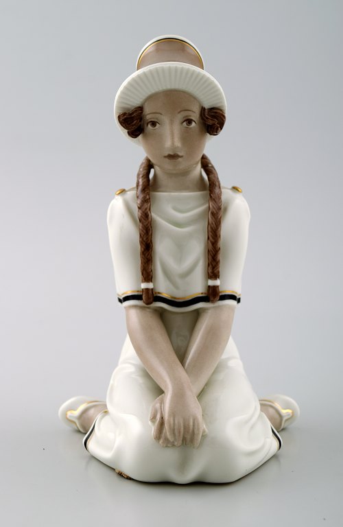 Arno Malinowski for Royal Copenhagen.
Sitting girl with braids. Overglaze.