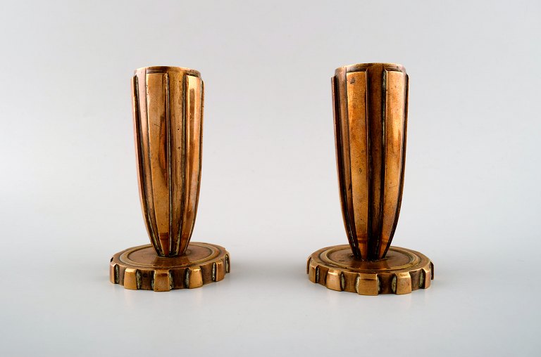 Tinos style art deco, a pair of candlesticks in bronze.
