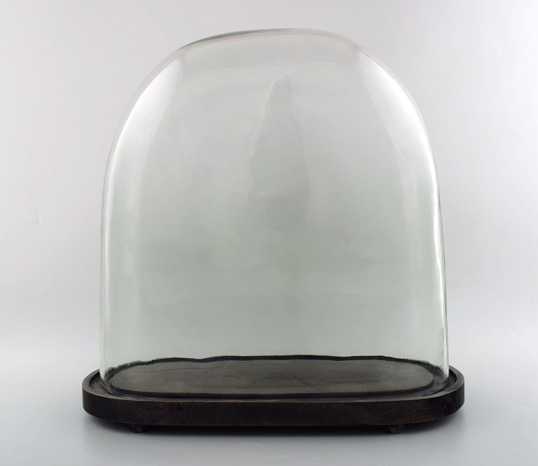 Large and old French glass globe of thick glass on wooden foot of dark wood.