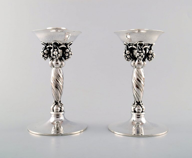 Georg Jensen, pair of candlesticks hammered sterling silver, adorned with 
twisted vines and grape bunches.