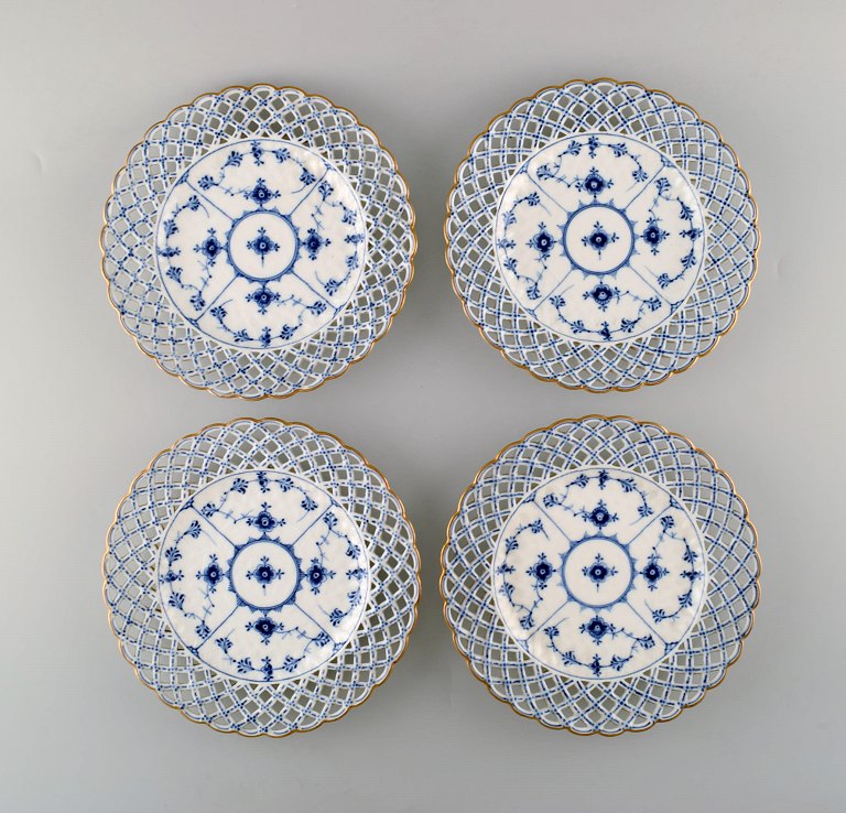 A set of 4 antique Royal Copenhagen Blue Fluted full lace plates with gold rim.