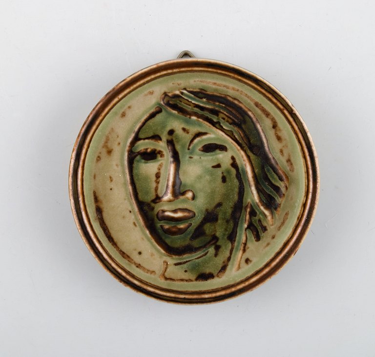 Jais Nielsen for Royal Copenhagen. Ceramic plaque with face in beautiful sung 
glaze. 1930