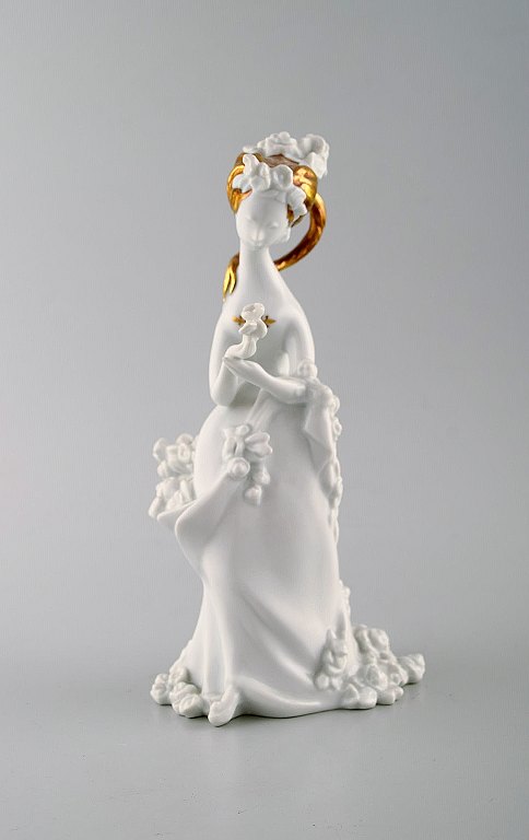 Bjørn Wiinblad for Rosenthal. Rare porcelain / blanc de chine figure with gold 
decoration. Girl with flowers. 1980