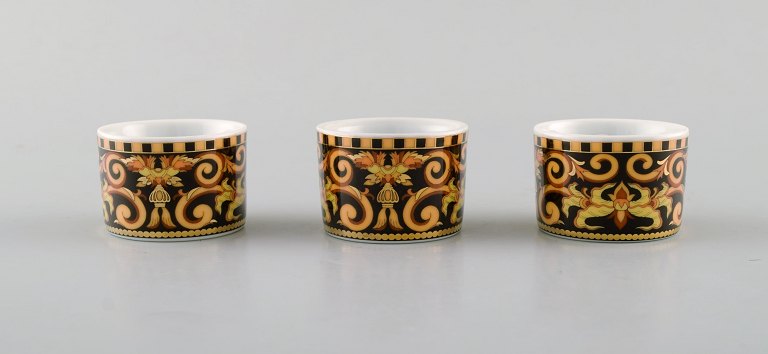 Gianni Versace for Rosenthal. Three "Barocco" porcelain napkin rings with gold 
decoration. 20th century.
