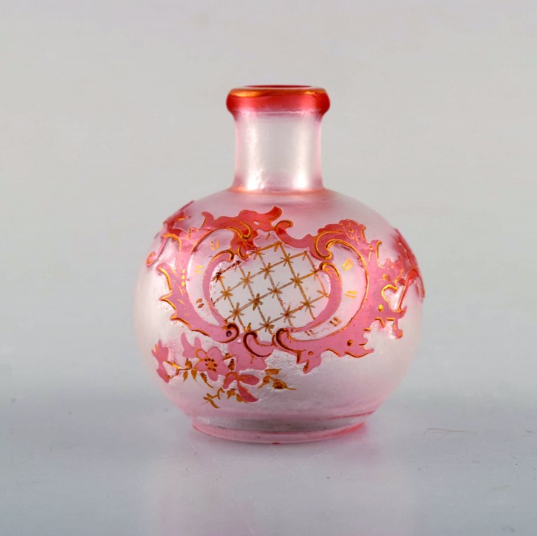 Daum Nancy, France. Pink art nouveau miniature vase in hand painted, mouth blown 
art glass. Floral and gold decoration. Ca. 1900.
