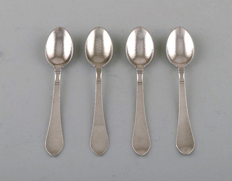 Georg Jensen "Continental" cutlery. Four coffee spoons in hammered sterling 
silver. Dated 1915-30.
