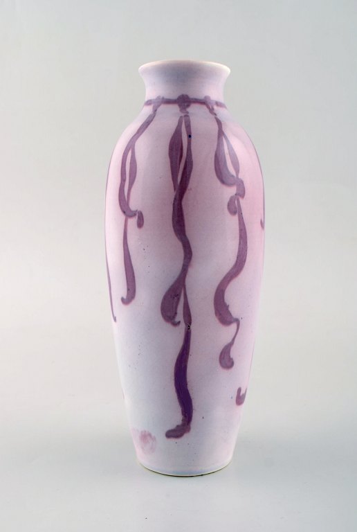 Gunnar Wennerberg for Gustafsberg. Unique art nouveau vase in glazed ceramics. 
Purple ribbon on pink background. Ca 1900.
