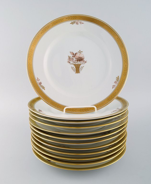 12 Royal Copenhagen "Golden Basket" dinner plates with gold edge. Model number 
9586. Mid 20th century.
