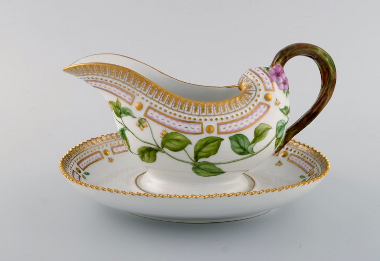 Royal Copenhagen Flora Danica sauce boat in hand-painted porcelain with flowers 
and gold decoration. Model number 20/3556.
