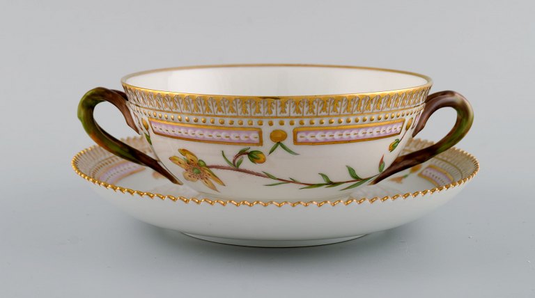 Royal Copenhagen Flora Danica boullion cup with saucer in hand-painted porcelain 
with branch-shaped handles, flowers and gold decoration. Model number 20/3612.
