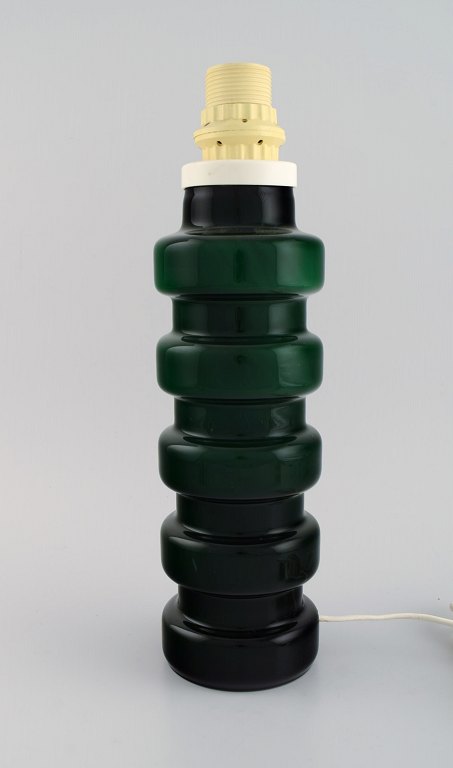 Swedish designer. Retro table lamp in green mouth blown art glass. 1970s.
