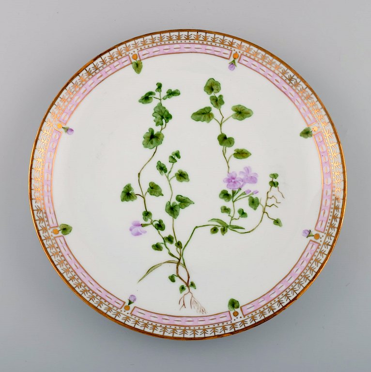 Dinner plate in Flora Danica style. Hand-painted flowers and gold decoration. 
Mid-20th century.
