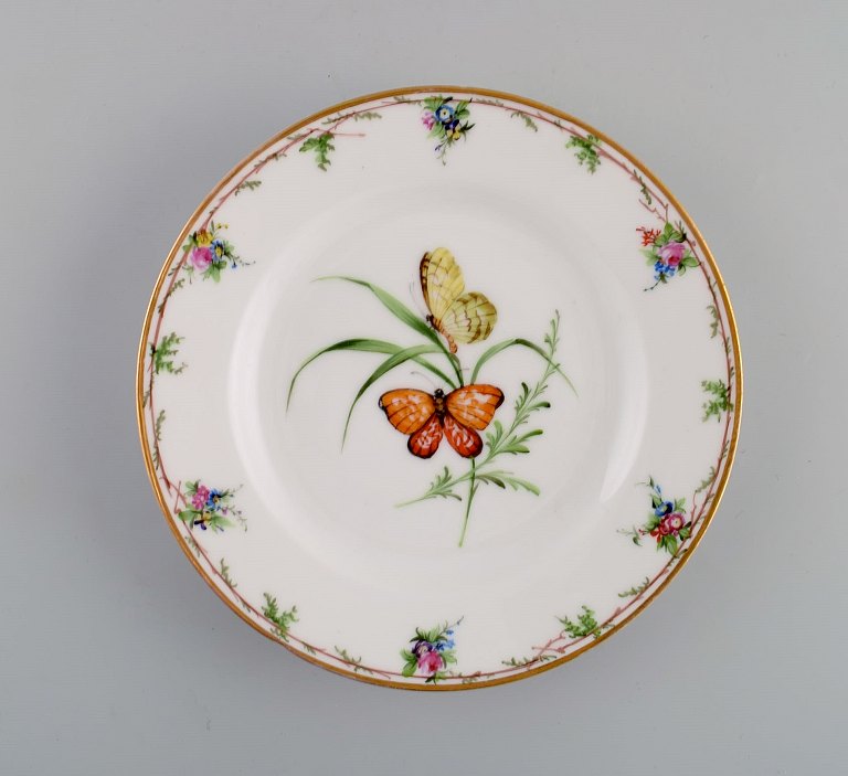 Antique Royal Copenhagen porcelain plate with hand-painted flowers, butterflies 
and gold edge. Mid-19th century.
