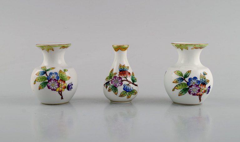 Three Herend porcelain vases with hand-painted flowers and butterflies. Mid-20th 
century.
