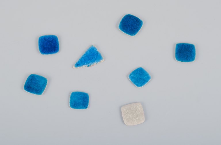 Ole Bjørn Krüger (1922-2007), Danish sculptor and ceramicist.Eight unique brooches in glazed stoneware in blue and white hues.
