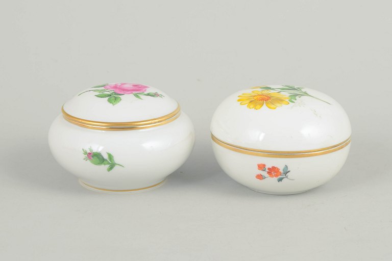 Meissen, set of two lidded jars with polychrome flower decoration.