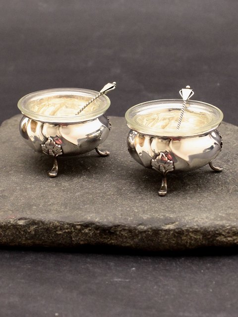 A pair of silver salt cellers with glass insert